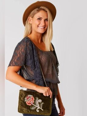 Velour Bag with Embroidered Orchid on the side, hangs from a Faux Gold Strap.